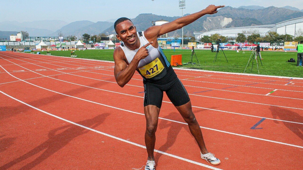 Animesh Kujur celebrates his record-breaking 100m run.