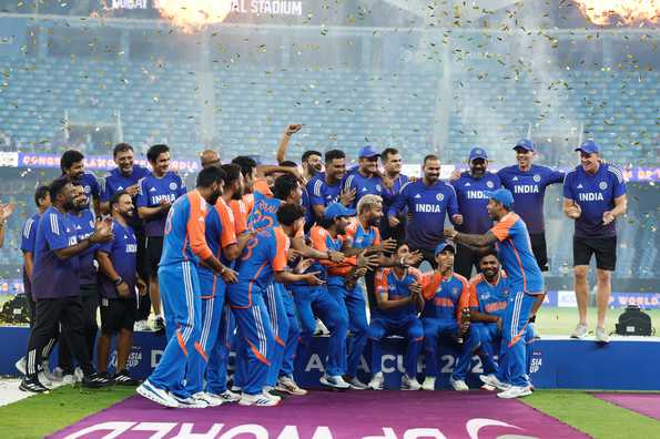 Suryakumar Yadav mimed lifting an imaginary trophy as his teammates cheered around him.
